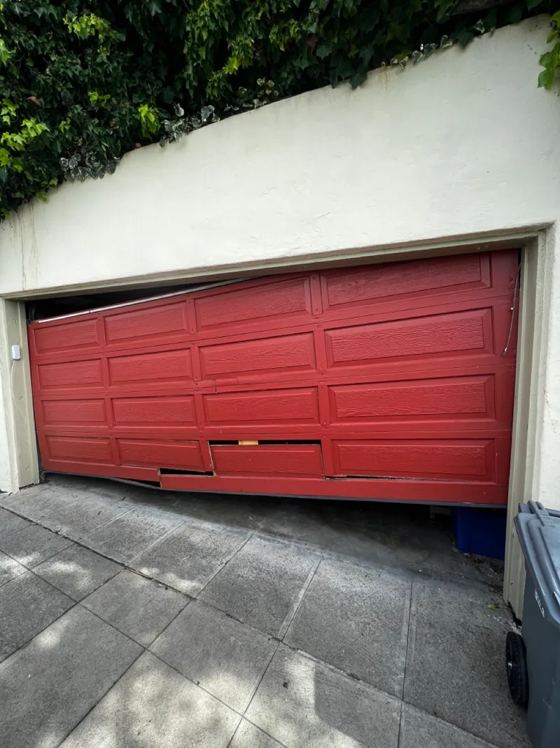 Technician repairing a residential garage door