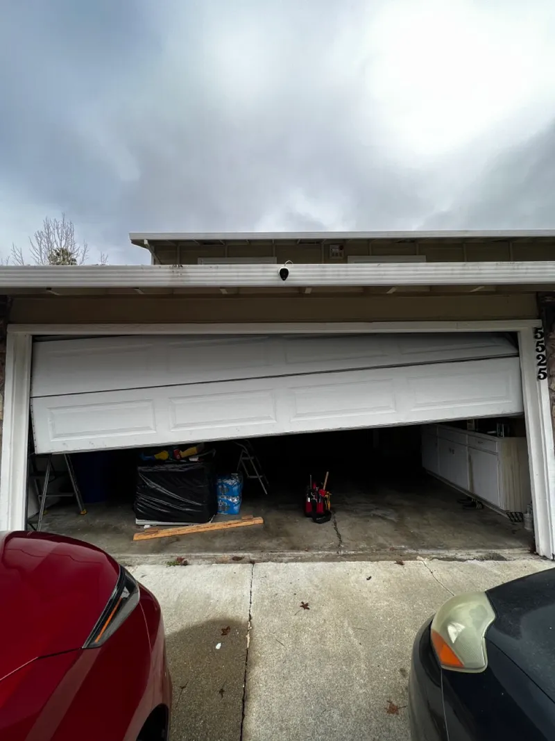 Garage door track and rollers being realigned